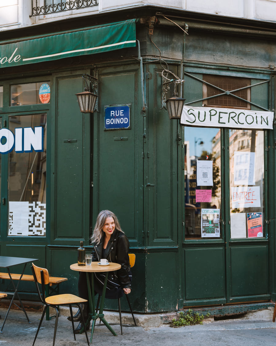 Amanda Bankert owner of Boneshaker Donuts and author of Voila Vegan sitting outside at a table in Paris