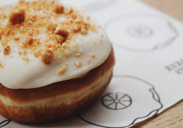 cream filled donut with icing and crumbles