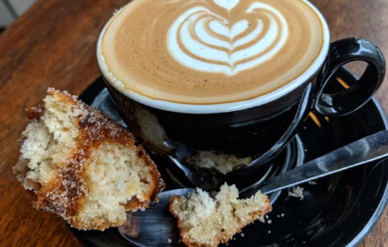 Coffee with cream latte design and doughnut